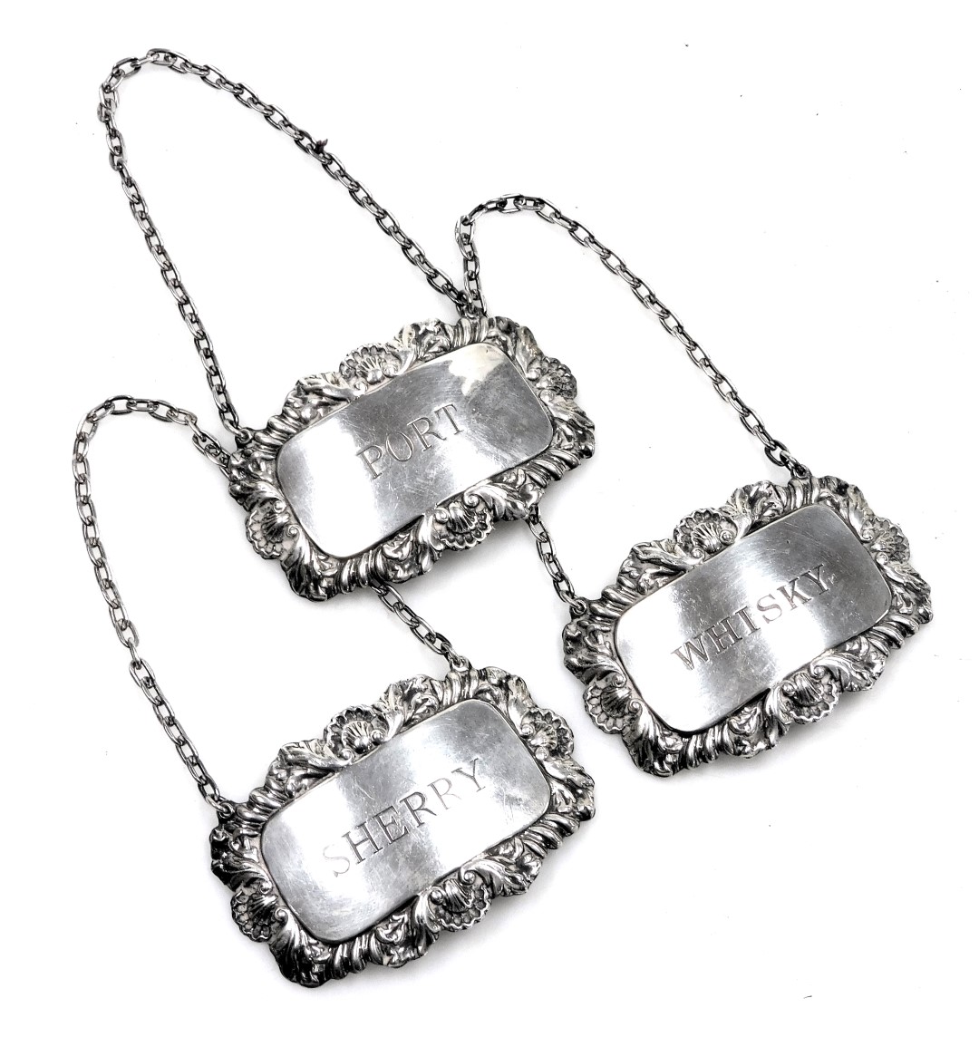 Three Elizabeth II silver decanter labels, on chains, for sherry, whisky and port, London 1967, 1.35