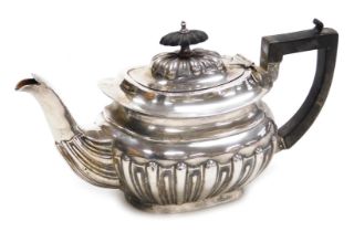 An Edward VII silver semi fluted tea pot, Birmingham 1904, 10.67oz all in.