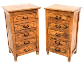 A pair of Eastern hardwood cabinets, each with a rectangular top and five drawers, on turned feet, 7