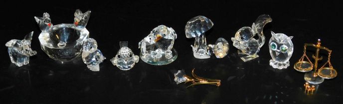 A group of Swarovski crystals, including a bird bath, small elephant, puffer fish, duckling, squirre