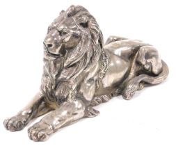 A Victorian silver plated paperweight of a lion, modelled in recumbent pose, 24.5cm wide.