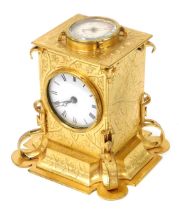 A Victorian brass cased desk clock, of Gothic form, with circular dial bearing Roman numerals, the t