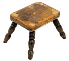 A 19thC ash and elm stool, the rectangular canted top on turned legs, 23cm wide.
