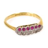 A ruby and diamond twelve stone ring, set with a row of each stone, in white and yellow metal, stamp