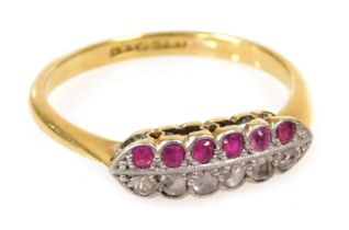 A ruby and diamond twelve stone ring, set with a row of each stone, in white and yellow metal, stamp