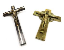 A 20thC brass crucifix, 30cm high, together with a wooden and white metal crucifix, 32.5cm high. (2)