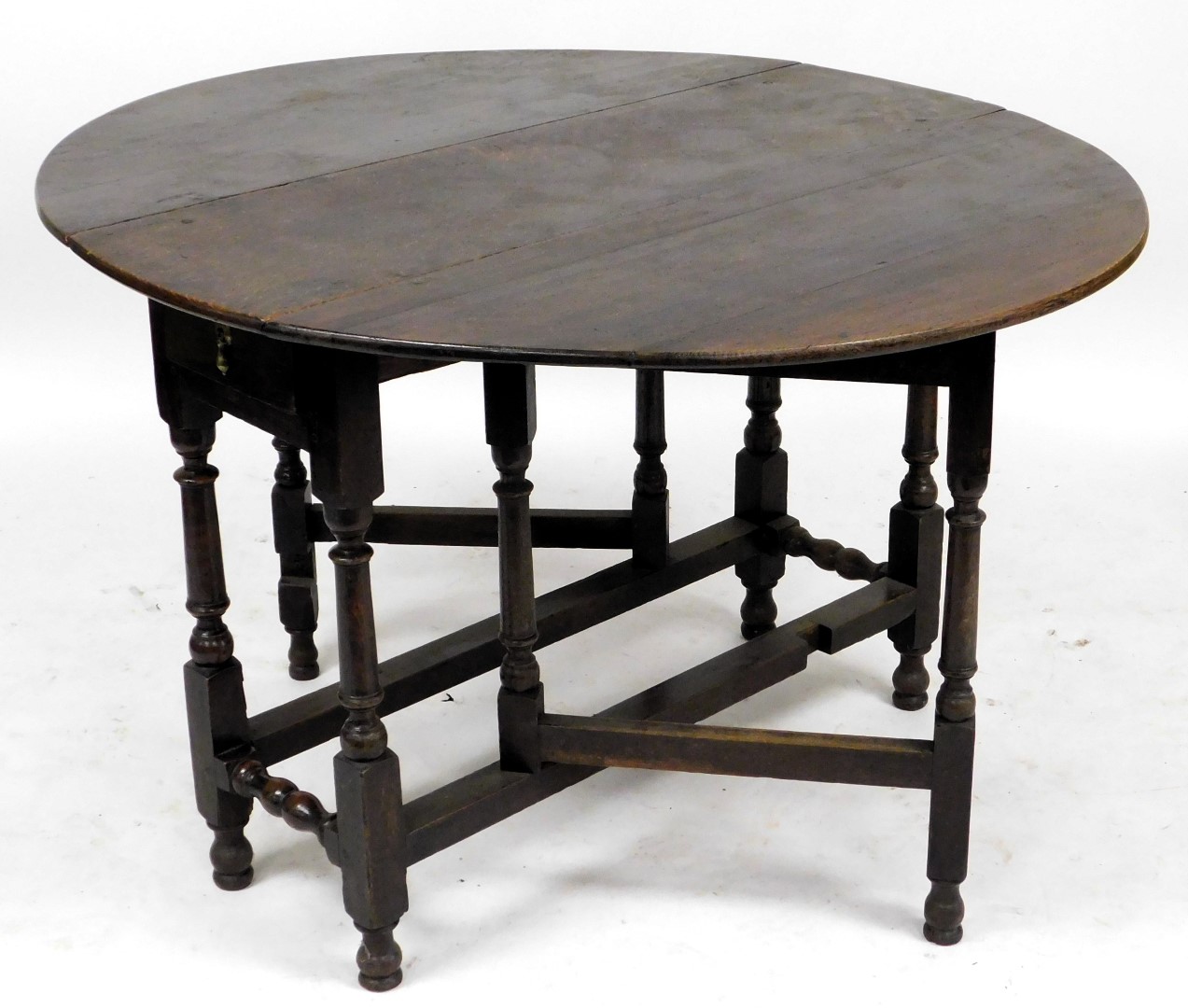 An 18thC oak drop leaf table, oval top on turned supports, 107cm wide. - Image 2 of 2