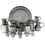 A group of Victorian and later pewter tankards, measures, jugs, and a charger. (qty)