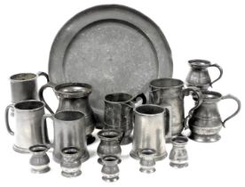 A group of Victorian and later pewter tankards, measures, jugs, and a charger. (qty)