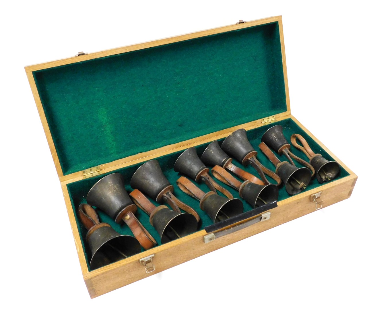 Twelve vintage graduated brass hand bells, with tan leather straps, denoting the note, cased.