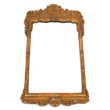 A gilt wall mirror, in early 18thC style, the frame with moulded decoration of scrolls, fleur de lis