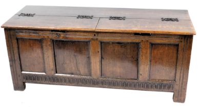 An oak and pine coffer, with a quadruple panelled front, on stiles, 69cm high, 185cm wide. (AF)