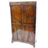 A mahogany wardrobe in George III style, with two panelled doors, on bracket feet, 179cm high, 108cm