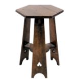 An Arts and Crafts oak occasional table, the hexagonal top on three tapering supports each with pier