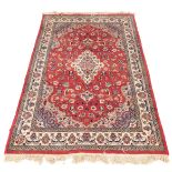 A Persian design rug, with central red ground gul, beige and grey borders, 195cm x 130cm.