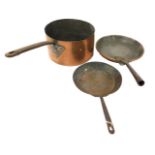 A Victorian copper saucepan, with a cast iron handle, the body stamped AH, 29cm wide, together with