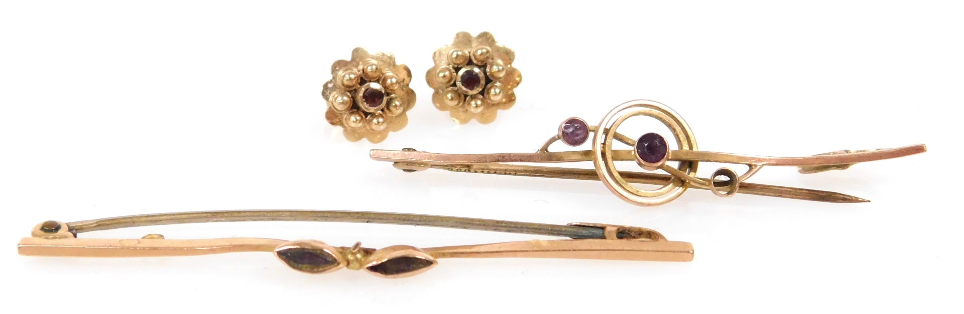 A pair of Edwardian 9ct gold and amethyst bar brooches, together with a pair of 9ct gold and garnet