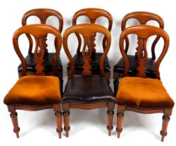 A set of six Victorian mahogany balloon back dining chairs, with a carved splat, and overstuffed bro