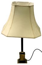 A brass column table lamp, on a square base with cream shade, 71cm high.