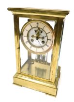 A late 19thC brass four-glass mantel clock, circular white dial with chapter ring bearing Roman nume