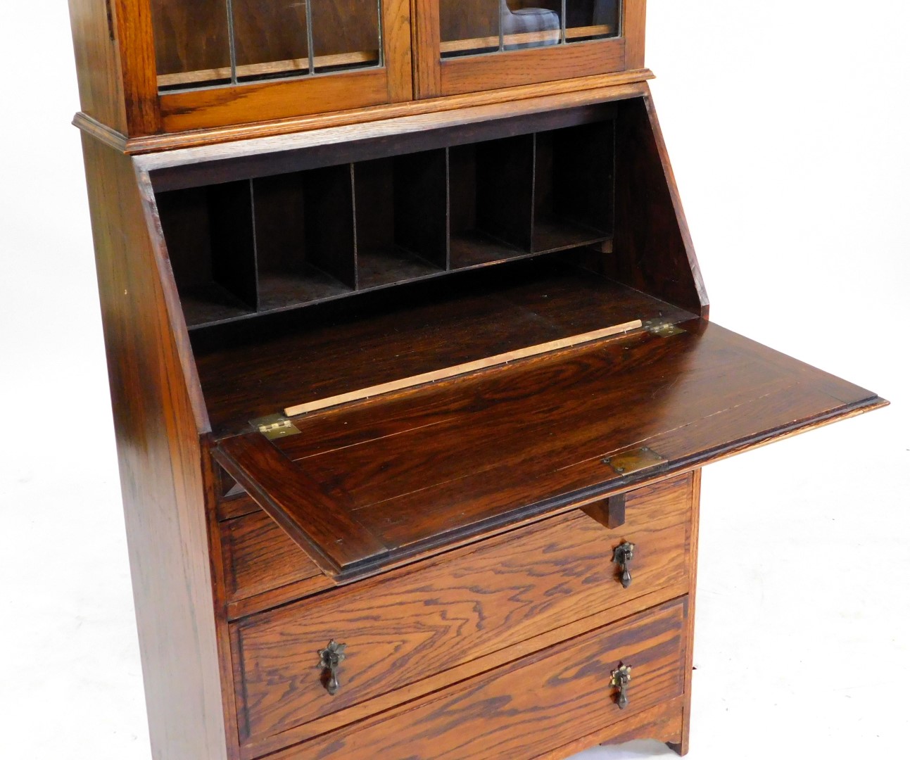 An oak bureau bookcase, topped with two leaded glazed doors, above a fall enclosing a partially fitt - Image 2 of 3
