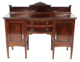 A Victorian mahogany serpentine sideboard, with two central drawers, flanked by a pair of cupboard d