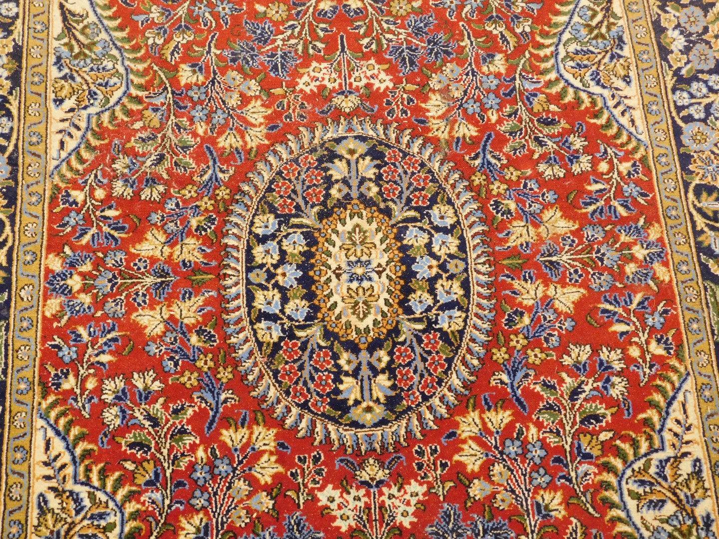 A Persian style rug, decorated with flowers and leaves, on a red ground within a cartouche, with cre - Image 2 of 3