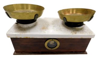 A set of early 20thC wooden, enamel and brass balance scales, weighing to 2lbs, 40cm wide.