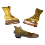 A pair of Victorian copper and brass boot makers ornaments, 11cm wide, and another similar, 14cm wid