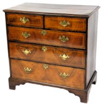 An 18thC oak and walnut chest of drawers, the rectangular top with moulded edge, above two short and