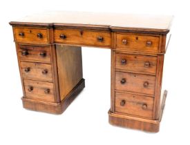 A 19thC mahogany kneehole desk, the rectangular inverted breakfront top with a moulded edge, above a