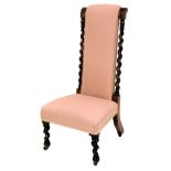 A late Victorian prie dieu chair, with a pink patterned padded back and seat, on spirally turned leg