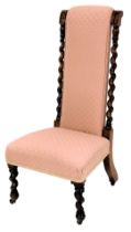 A late Victorian prie dieu chair, with a pink patterned padded back and seat, on spirally turned leg