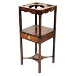 A George III mahogany wash stand, square top with recesses for a bowl and two beakers, above an unde