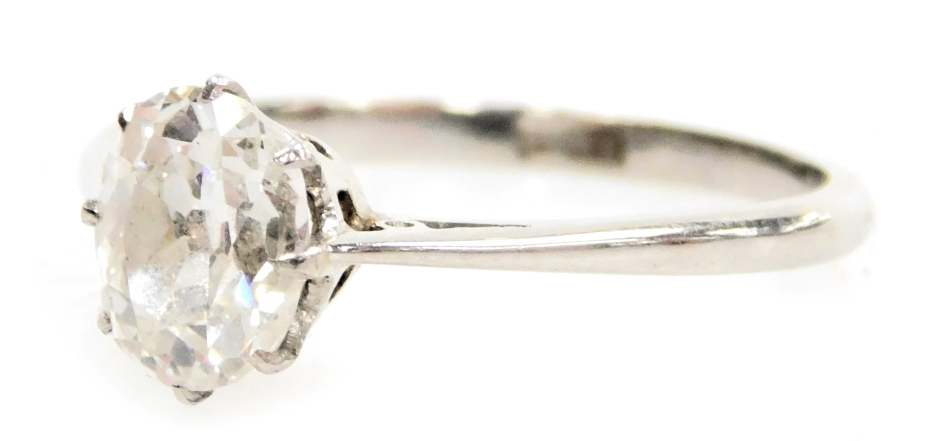 An early 20thC oval diamond and platinum solitaire ring, high claw set, approximately 0.9ct, size N,