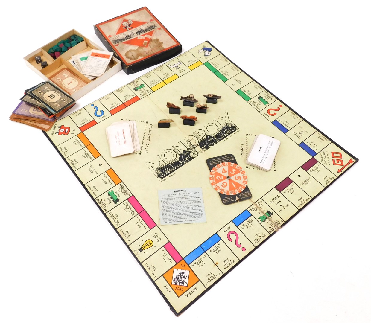 A vintage game of Monopoly, by John Waddington Ltd, containing cardboard playing figures.