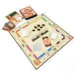 A vintage game of Monopoly, by John Waddington Ltd, containing cardboard playing figures.