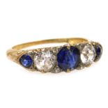 An early 20thC blue and white sapphire five stone ring, set with old cut diamond chippings and the p