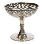 A George V loaded silver pedestal sweet meat dish, with pierced decoration, Chester 1911, 12cm high,