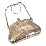 A George V silver evening purse, engraved with floral swags and foliate scrolls, on a chain link sus