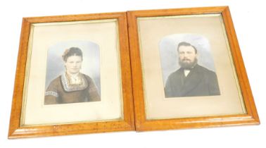 A pair of 19thC over painted photographs, portraits of a gentleman and lady, in a burr maple frame,