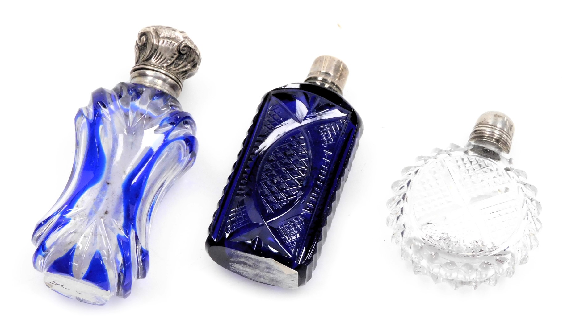 Three Victorian cut glass scent bottles, one of blue flushed waisted form, with a plated mount and h