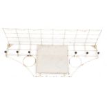 A mid century atomic white cast iron coat rack, wall mounted with central square glass mirror plate,