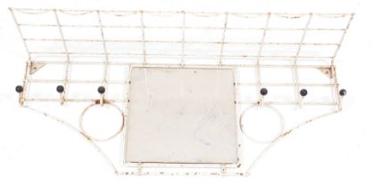 A mid century atomic white cast iron coat rack, wall mounted with central square glass mirror plate,