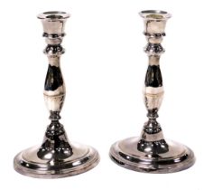 A pair of Regeny Old Sheffield Plate candlesticks, of baluster form, raised on an oval base, 24cm hi