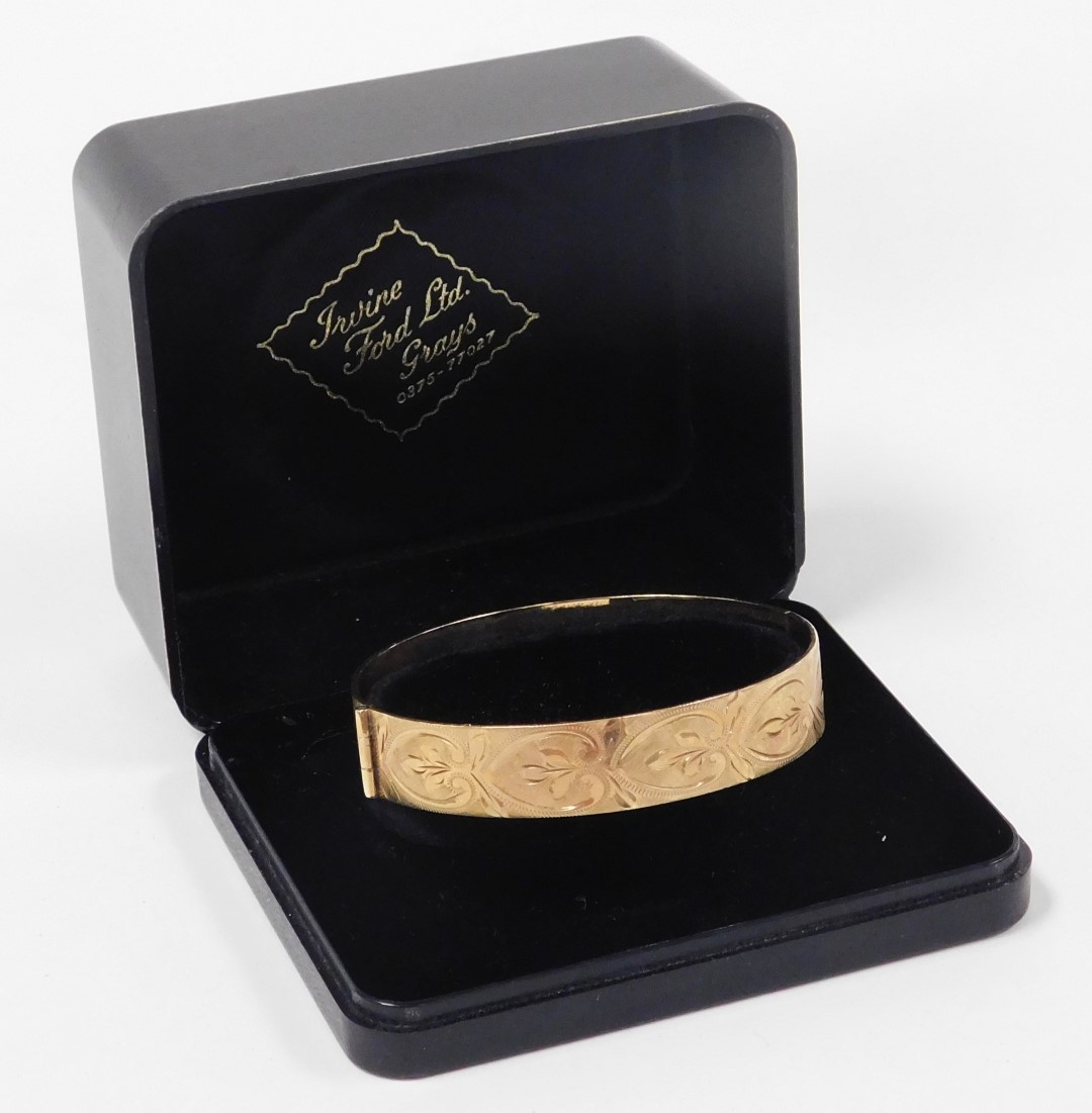 A 9ct gold bangle, with engraved repeating acanthus leaf decoration, on a snap clasp, 24.5g. - Image 3 of 3