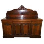 A Victorian mahogany break front sideboard, with a carved back over one long and two short cushion d