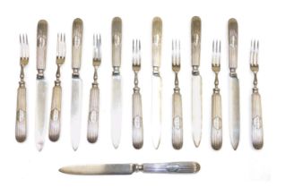 Fourteen early 20thC silver plated fruit knives and forks, the handles with a shield reserve engrave