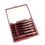 A set of six Elizabeth II silver handled cake knives, cased, Sheffield 1951.