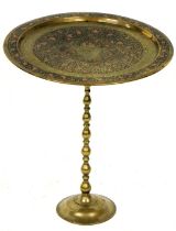 A mahogany occasional table, formed from an Indian engraved and coloured circular tray, on a turned